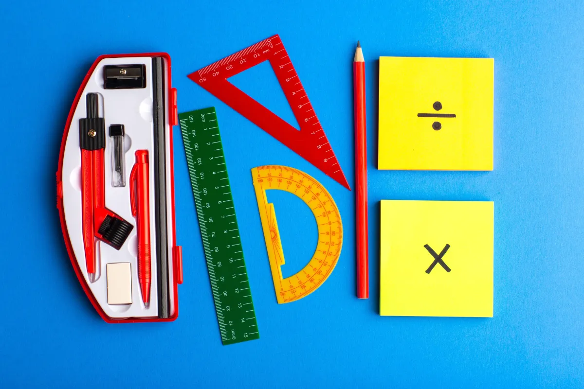 front-view-geometric-figures-with-pencil-stickers-blue-surface